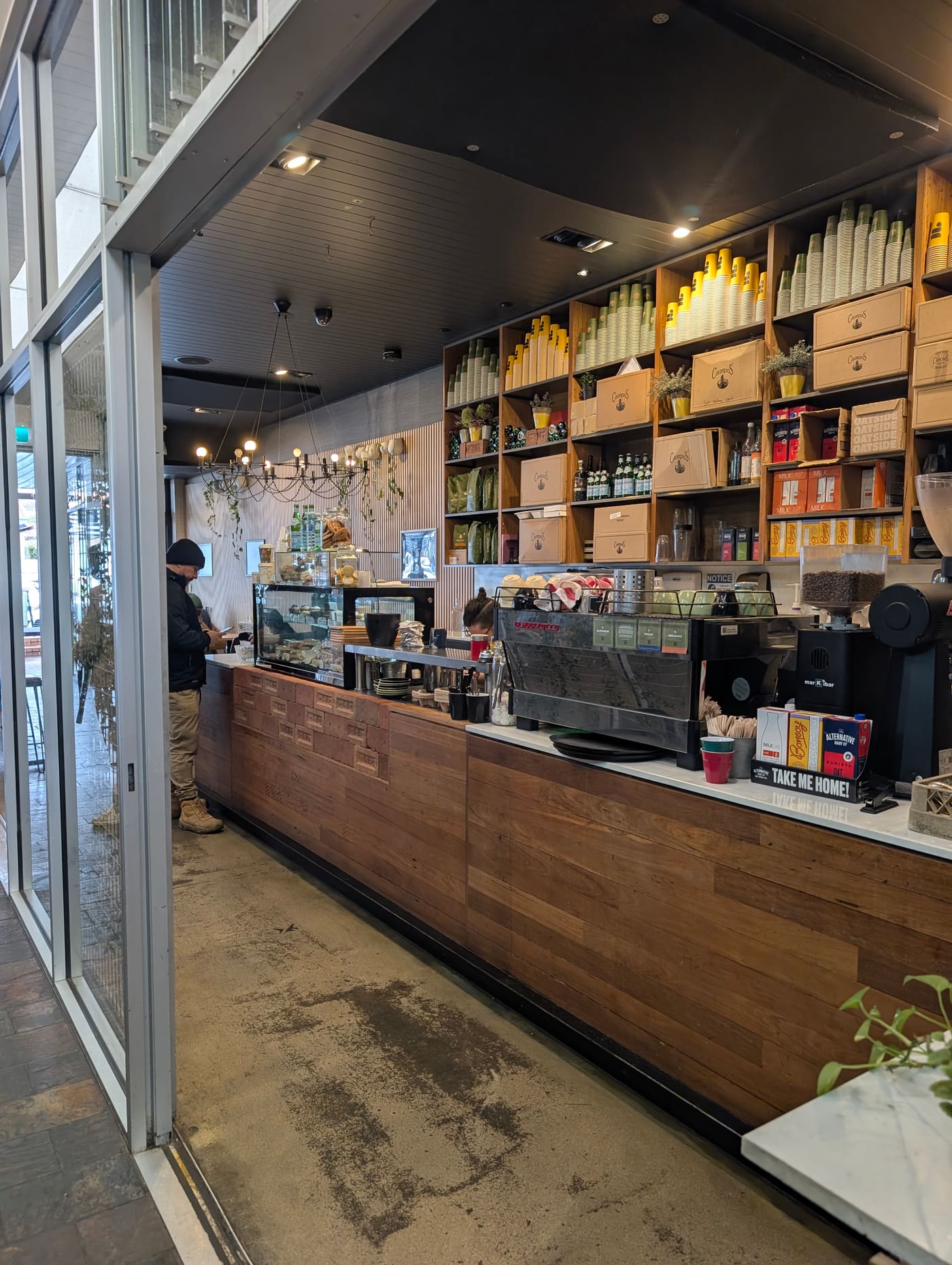 The espresso bar at Farmers Daughter, lined with Campos coffee and reusable cups