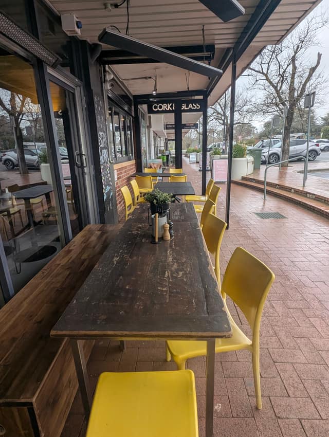 Alfresco seating with yellow chairs on Bentham Street